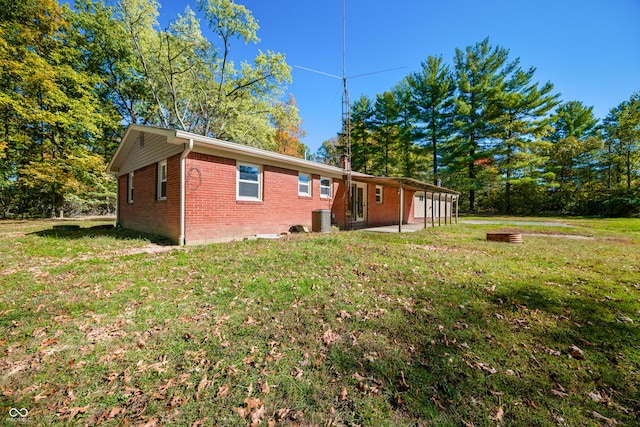 3233 Plum Creek Rd, Nashville, IN 47448 - exterior space with a front yard, brick siding, central AC, and a patio area