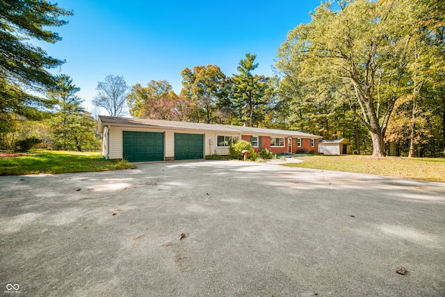 ranch-style home with a front yard and a garage