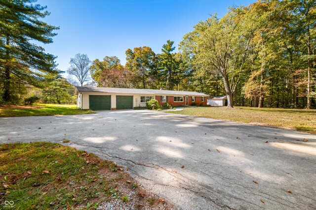 3233 Plum Creek Rd, Nashville, IN 47448 - exterior space featuring an attached garage, a yard, and driveway