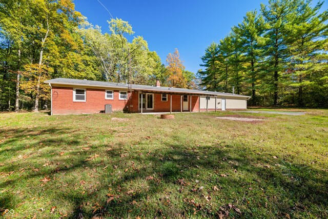 3233 Plum Creek Rd, Nashville, IN 47448 - back of house with a lawn, a chimney, and brick siding