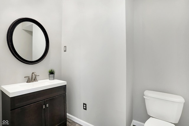 bathroom featuring toilet and vanity