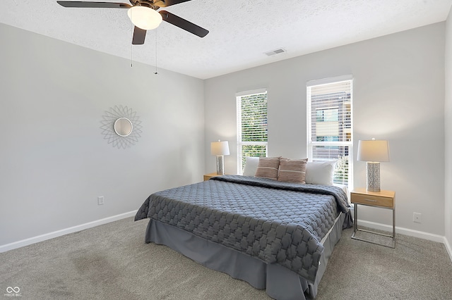 bedroom with ceiling fan, a textured ceiling, and carpet floors