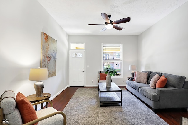 living room featuring dark hardwood / wood-style floors and ceiling fan