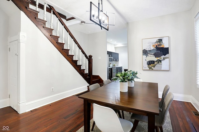 dining space with a notable chandelier and dark wood-type flooring