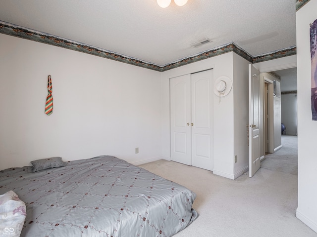 unfurnished bedroom with light carpet, a closet, and a textured ceiling