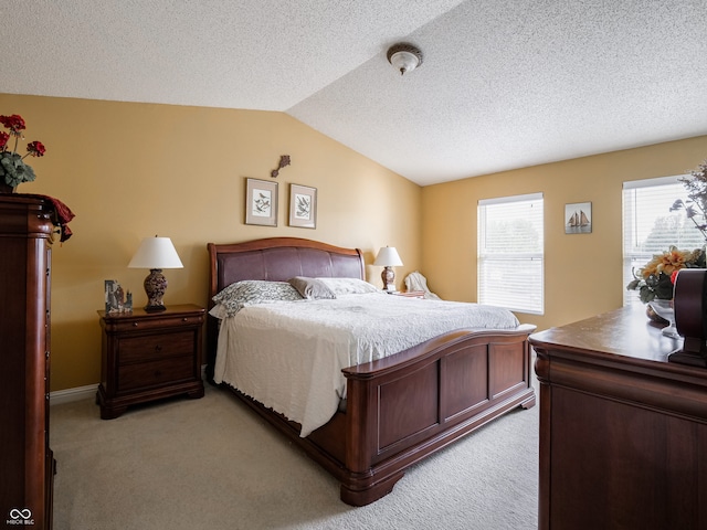 carpeted bedroom with vaulted ceiling and a textured ceiling