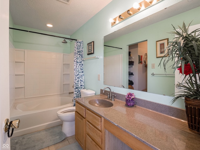 full bathroom with shower / tub combo, a textured ceiling, toilet, vanity, and tile patterned floors