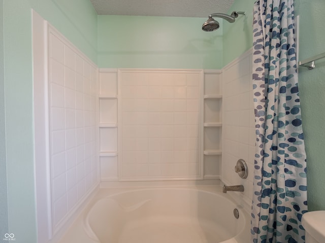 bathroom with a textured ceiling, shower / tub combo with curtain, and toilet