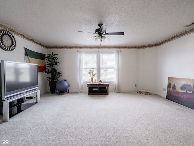 unfurnished room featuring a textured ceiling, carpet flooring, and ceiling fan