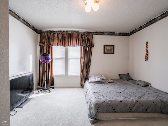 bedroom featuring carpet floors and a textured ceiling