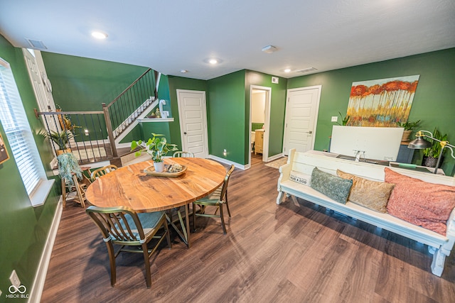 dining space with dark hardwood / wood-style flooring