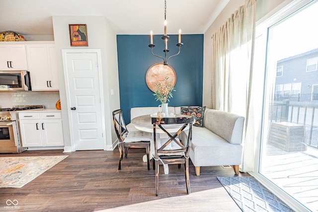 dining space with an inviting chandelier and dark hardwood / wood-style floors