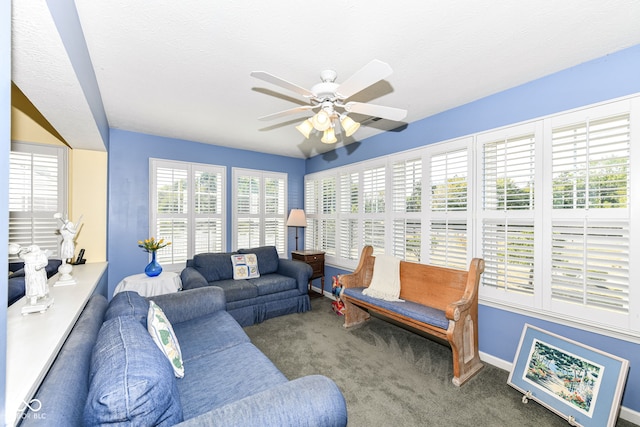 living room featuring ceiling fan, carpet flooring, and a textured ceiling