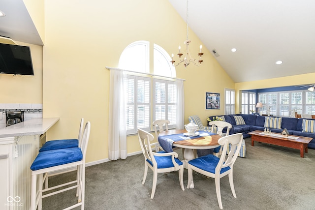 dining room featuring high vaulted ceiling, carpet floors, plenty of natural light, and ceiling fan with notable chandelier