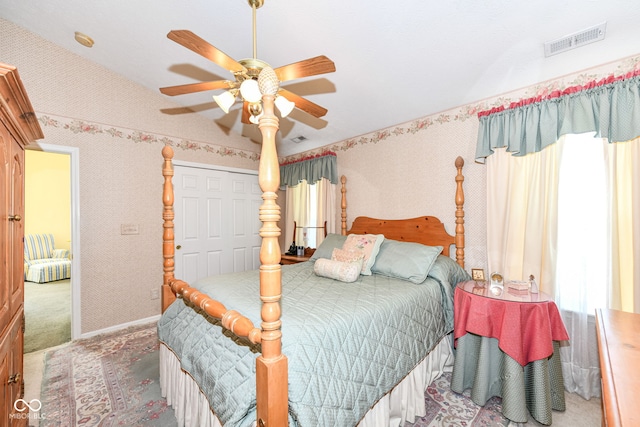 carpeted bedroom featuring vaulted ceiling, a closet, and ceiling fan