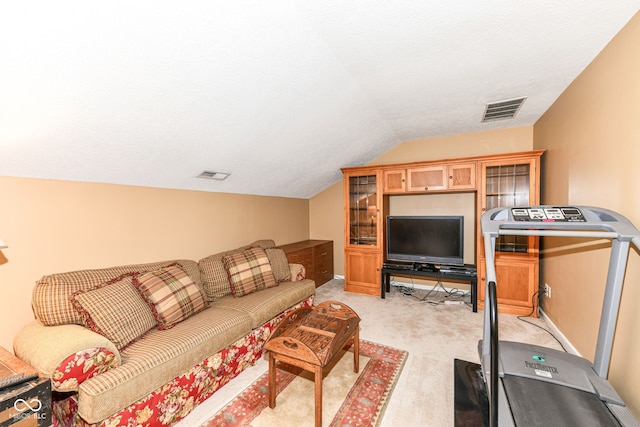 living room with lofted ceiling, a textured ceiling, and light colored carpet