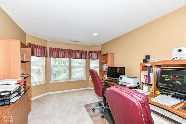 home office featuring light carpet and a textured ceiling