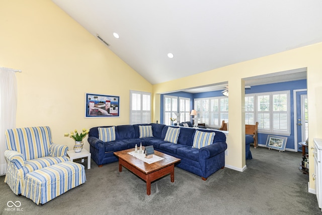 carpeted living room featuring high vaulted ceiling