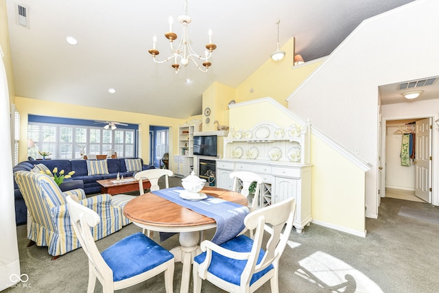 dining room with light colored carpet, high vaulted ceiling, and ceiling fan with notable chandelier