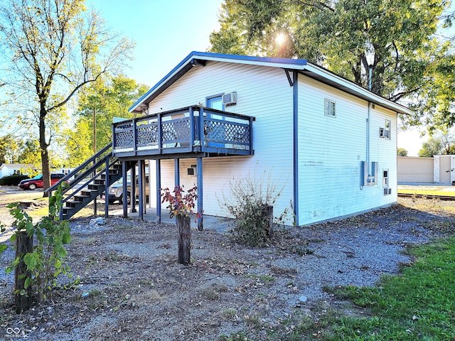 rear view of house with a wooden deck