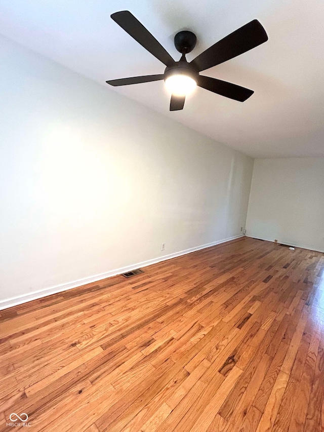 spare room featuring light hardwood / wood-style flooring and ceiling fan