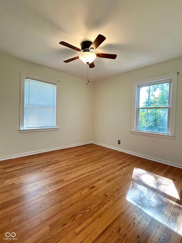 spare room with light hardwood / wood-style floors and ceiling fan