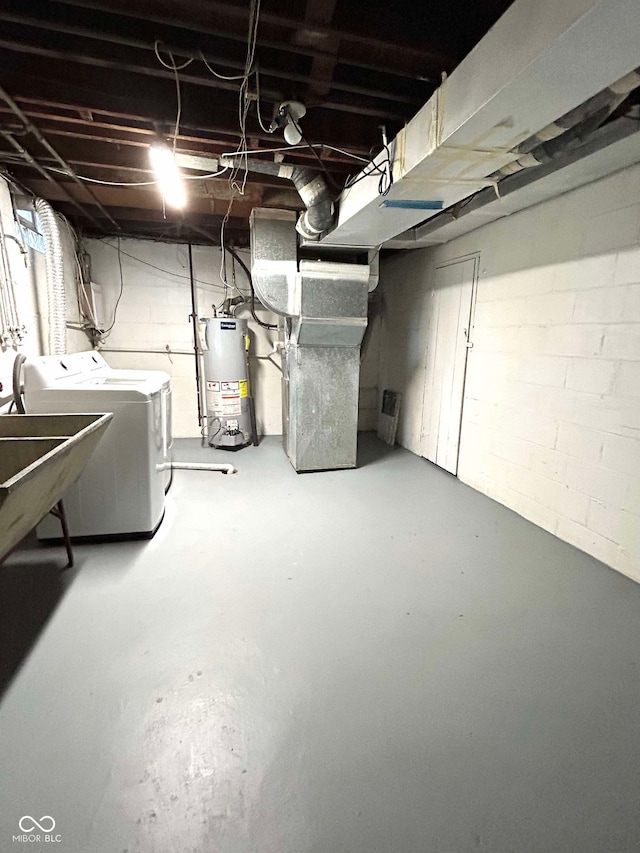 basement with water heater, washer and clothes dryer, and heating unit