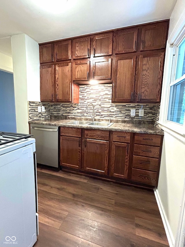 kitchen with dishwasher, stove, sink, and dark wood-type flooring