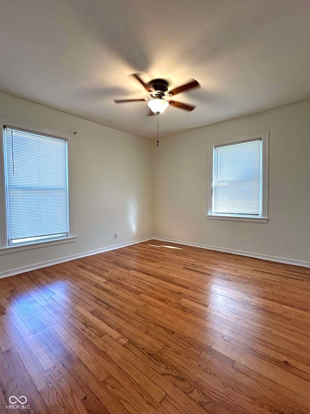 spare room with ceiling fan and light wood-type flooring