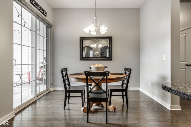 dining room featuring dark hardwood / wood-style floors and a chandelier