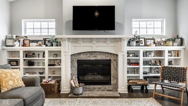 living room with a wealth of natural light and dark wood-type flooring