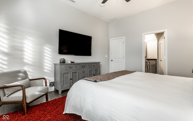 bedroom with ceiling fan, hardwood / wood-style flooring, and ensuite bath