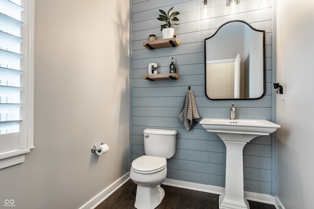 bathroom featuring toilet, hardwood / wood-style flooring, and a wealth of natural light