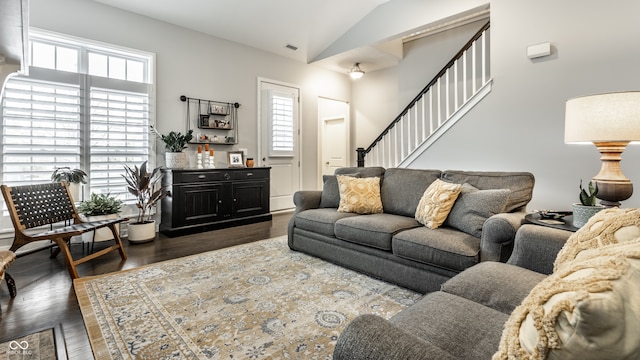 living room with dark wood-type flooring and lofted ceiling