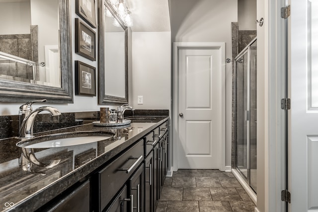 bathroom featuring vanity and a shower with door