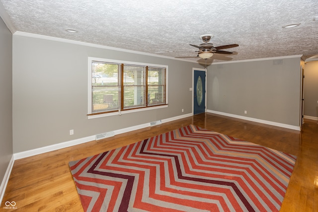 unfurnished room with ornamental molding, a textured ceiling, hardwood / wood-style flooring, and ceiling fan