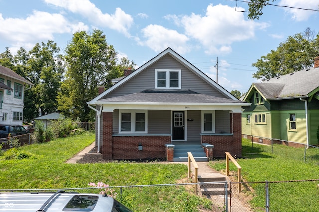 bungalow-style home featuring a porch and a front lawn