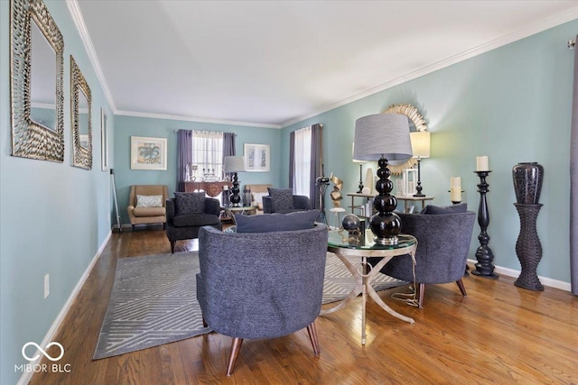 living room featuring baseboards, wood finished floors, and crown molding