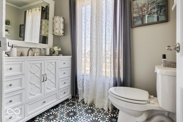 bathroom with vanity, crown molding, toilet, and tile patterned floors