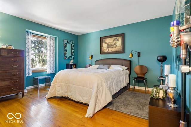 bedroom featuring baseboards and wood finished floors