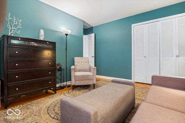 living area featuring baseboards and wood finished floors