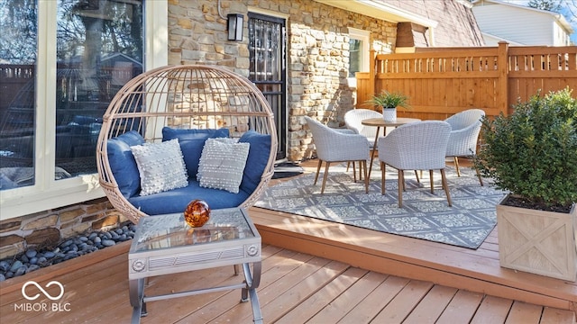 wooden terrace featuring fence