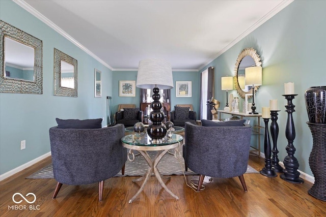 living room featuring ornamental molding, baseboards, and wood finished floors