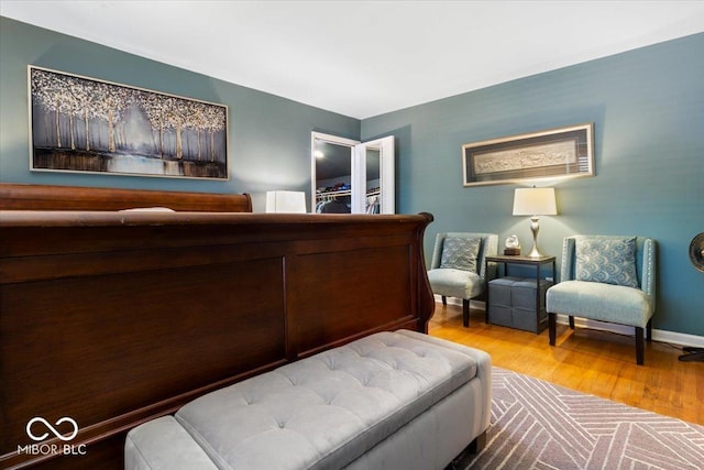 bedroom featuring wood finished floors and baseboards