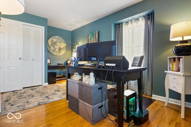 home office with wood finished floors and baseboards