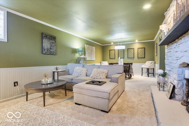 living room with a wainscoted wall, carpet floors, and ornamental molding