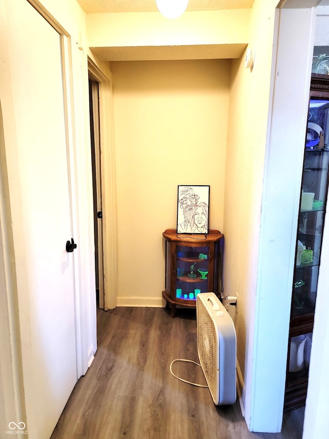 corridor featuring dark hardwood / wood-style flooring