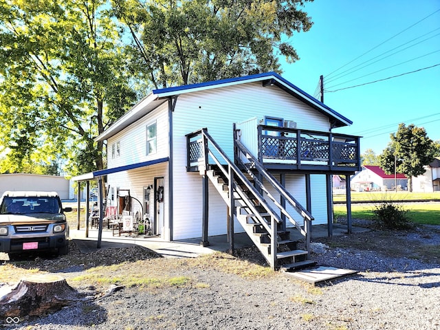 exterior space featuring a wooden deck and a carport