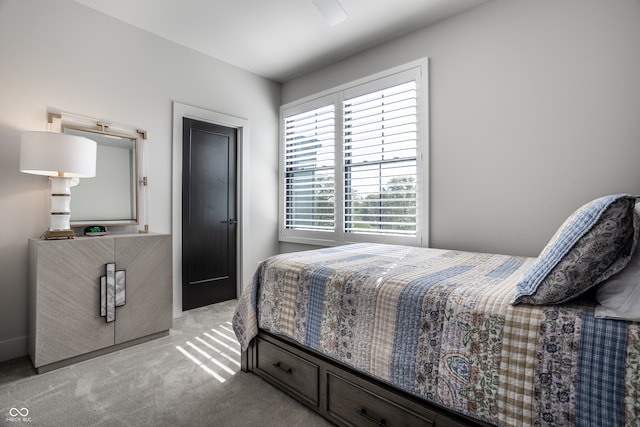 bedroom with light carpet and ceiling fan