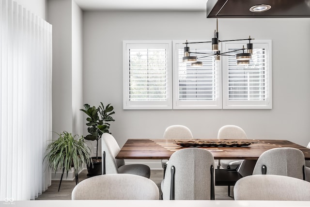 456 Monon Way Dr, Carmel, IN 46032 - dining space with an inviting chandelier, wood finished floors, and baseboards